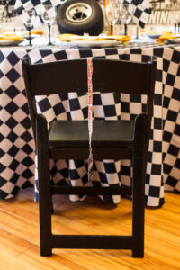 A Classic party rental black padded resin chair for your next Indy 500 party
